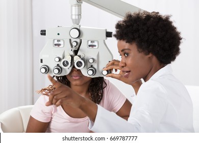 Female African Optometrist Doing Sight Testing For Patient In Hospital