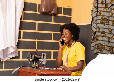 Female African Tailor Making A Phone Call