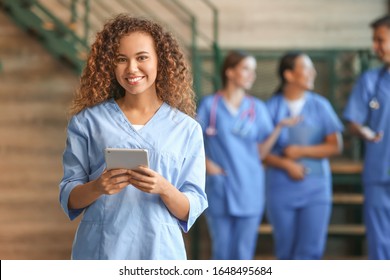 Female African-American Medical Student With Tablet Computer In Clinic