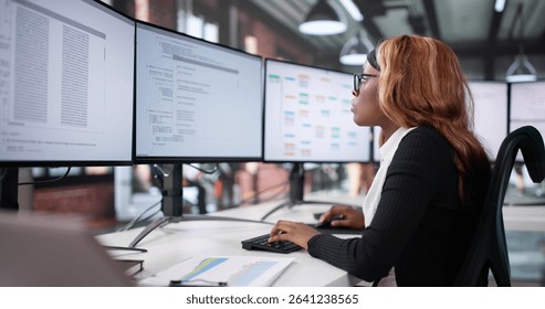 Female African-American Software Engineer Developing Code On Desktop Computer Screen.