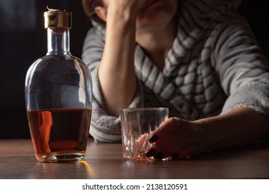 Female Alcoholism. Female Woman Sit To Table Drink Alcohol Bottle At Home Sad Alone Alcoholism Signs And Symptoms Rehab Abuse And Recovery Problems.