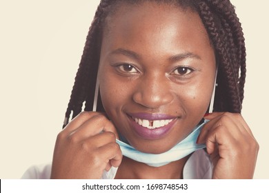 Female American African Doctor, Nurse Woman Wearing Medical Coat With Stethoscope And Mask. Happy Excited For Success Medical Worker Posing On Light Background. Pandemia Concept, Covid 19