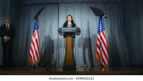 Female American republican politician delivers successful speech to supporters at government election rally. President of USA gives interview for journalists. Backdrop with American flags. Dolly shot. - Powered by Shutterstock