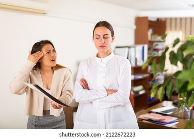 Female Angry Boss Blaming Upset Woman Office Worker In Office