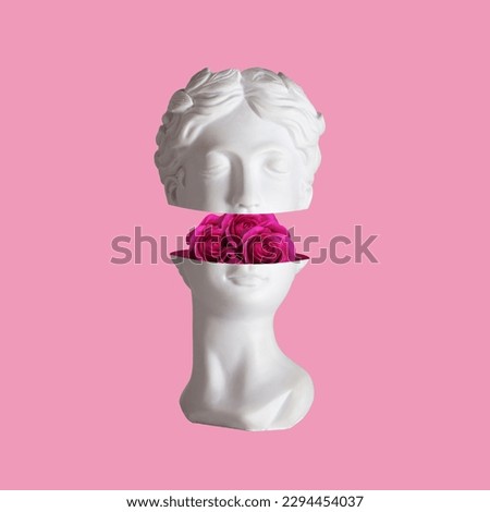 Female antique statue's head with pink flowers roses in the cut isolated on a color background. The beauty inside. Trendy collage in magazine surreal style. 3d contemporary art. Modern design