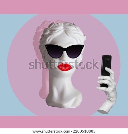 Female antique statue's head with red lips wearing black sunglasses takes selfie with mobile phone on color background. 3d trendy collage in magazine style. Contemporary art. Modern design