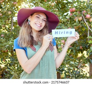 Female Apple Farmer Hiring Workers To Help On Her Fruit Farm During Harvest. Portrait Of Happy Young Woman Advertising Jobs And Finding Recruitment In An Orchard On A Sunny Day Near Trees.