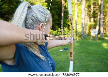 Similar – Attractive young woman with a rifle at the ready aims at her target and has her finger on the trigger