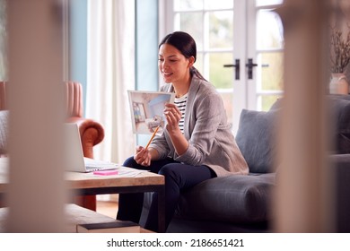 Female Architect Or Interior Designer Working From Home Having Meeting Via Video Call