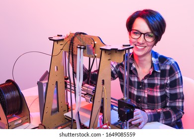 Female architect using 3D printer in office