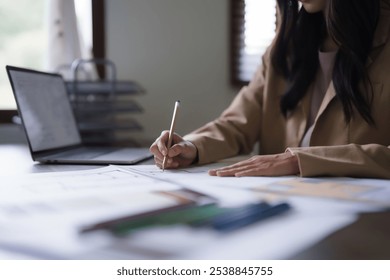 Female architect work to designing interior building and drawing construction project on blueprint. - Powered by Shutterstock