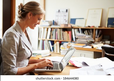 Female Architect Working At Desk On Laptop