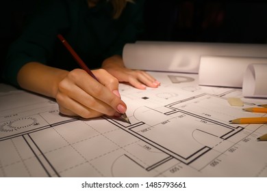 Female Architect Working Late In Evening