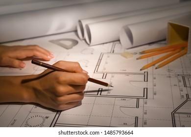 Female Architect Working Late In Evening