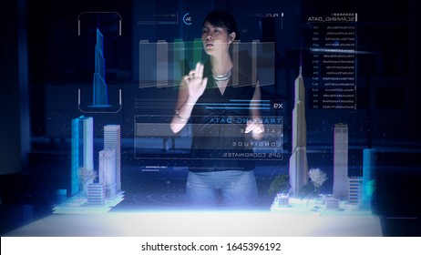 Female Architect works with Holographic Augmented Reality 3D City Model using gestures showing graphs. Technologically Advanced Office with Augmented Virtual Modeling Software on Futuristic Display. - Powered by Shutterstock - Get 15% off with code: PIKWIZARD15
