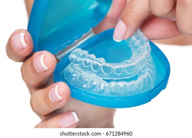 Female Arms Showing Clear Aligners In Case