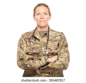 Female Army doctor or nurse in uniform on white background.  Female US Soldier in the medical field with arms crossed looking serious.