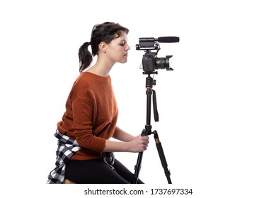 Female Art Student Studying To Be A Filmmaker Using A Camera On A Tripod For A Project. She Looks Confident About Her Creativity. Depicts Entertainment Industry Production And Education