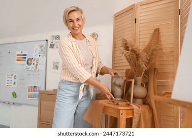 Female art teacher preparing decor for still life at school - Powered by Shutterstock