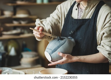 Female artisan business, potter making ceramic vase for sale in handmade store - Shutterstock ID 2152230355