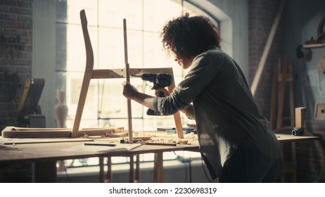 Female Artisan Furniture Designer Entering Workshop, Starting to Assemble a Wooden Chair with an Electric Screwdriver. Multiethnic Black Carpenter Working in a Studio. - Powered by Shutterstock