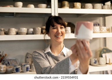 Female Artisan Happy With The Final Result Of Her Ceramic Work