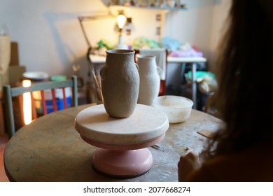 Female Artisan Looking At Ready Potter Jug After Master Class In Studio. Woman Art Student In Workshop Practice Handmade Ceramics Production For Small Entrepreneurship And Handicraft Shop Ownership