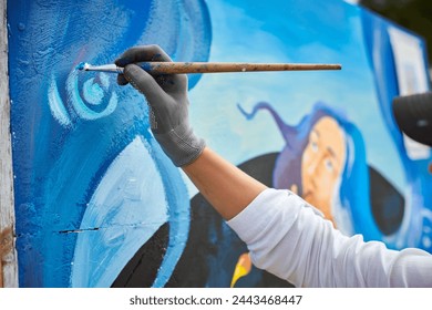 Female artist hand applies small brushstrokes of paint with paintbrush to canvas creating picture for exhibition, close up view of female hand painter creative process - Powered by Shutterstock