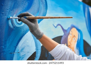 Female artist hand applies small brushstrokes of paint with paintbrush to canvas creating picture for exhibition, close up view of female hand painter creative process - Powered by Shutterstock