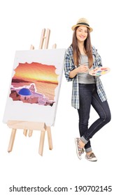 Female Artist Leaning On An Easel With Painting Isolated On White Background