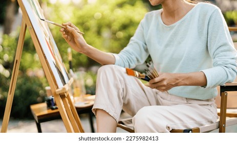 Female artist painting art canvas drawing with inspiration in garden art therapy creativity concept. - Shutterstock ID 2275982413