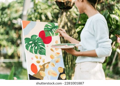 Female artist painting art canvas drawing with inspiration in garden art therapy creativity concept. - Powered by Shutterstock