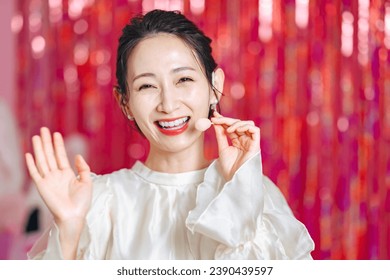 A female artist performs with a head microphone on a gorgeous stage. - Powered by Shutterstock