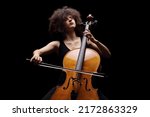 Female artist playing a contrabass isolated on black background