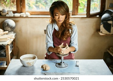 Female artist sculpts crafts with ceramic clay at her creative workshop. Mastering the art of pottery craft ceramics - Powered by Shutterstock