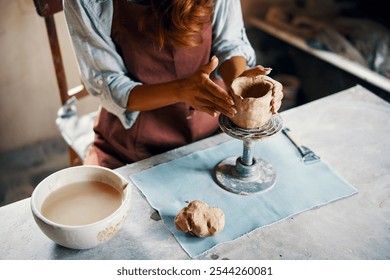 Female artist sculpts crafts with ceramic clay at her creative workshop. Mastering the art of pottery craft ceramics - Powered by Shutterstock