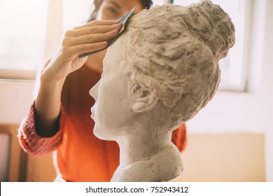 Female artist working in atelier.  Art and Sculpture.	