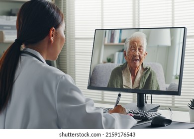 Female Asian doctor making video call with Asian senior woman grey hair 80-90s, telemedicine telehealth concept - Powered by Shutterstock