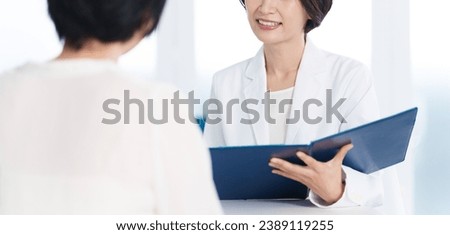 female asian doctor talking with patient at hospital