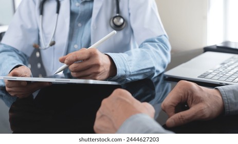 Female asian doctor using digital tablet, writng prescription for her patient, medical screening, medical examination at medical clinic, close up - Powered by Shutterstock