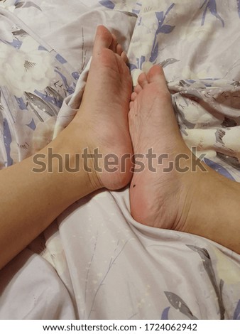 Female Asian feet on luxurious silk