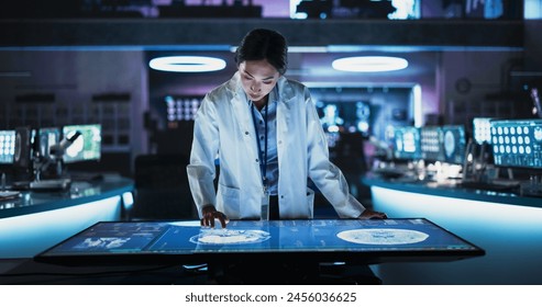 Female Asian Neuroscinetist Using Interactive Touch Screen Table With MRI Scans On Display In Modern Biotechnology Research Center. Doctor Developing Innovative Devices For People With Alzheimer's. - Powered by Shutterstock