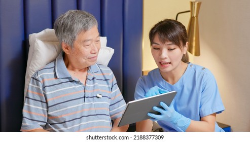 Female asian nurse or health worker is explaining treatment plan to elderly senior man patient by digital tablet and giving recommendations - Powered by Shutterstock