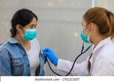 Female Asian pediatrician hold stethoscope exam girl patient visit doctor in the clinic