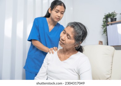 Female asian physiotherapist worker giving neck massage to mature woman, closeup. Rehabilitation physiotherapy in rehabilitation center, neck pain - Powered by Shutterstock