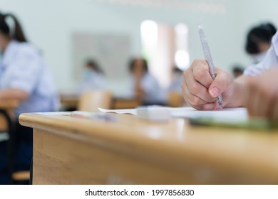 Female Asian Student Study Together Reading Document Wearing Facemask Prevent COVID-19 Coronavirus, Taking Exam Test At Classroom High School Of Thailand Concentration Admission SAT PISA In Evaluation