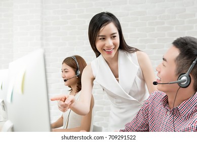 Female Asian Supervisor Training Work With Telemarketing Customer Service Agent Team In Call Center