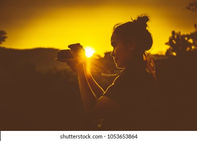 female asian traveler photographer 
 landscape outdoor Silhouette at sunset  Young woman. - Powered by Shutterstock