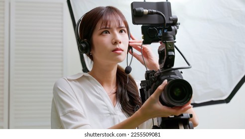 Female Asian Videographer with confident while video tapping - Shutterstock ID 2255509081