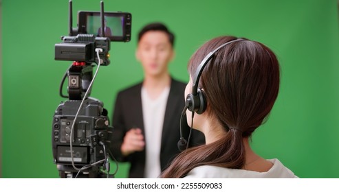 Female Asian Videographer satisfied with result of video shooting